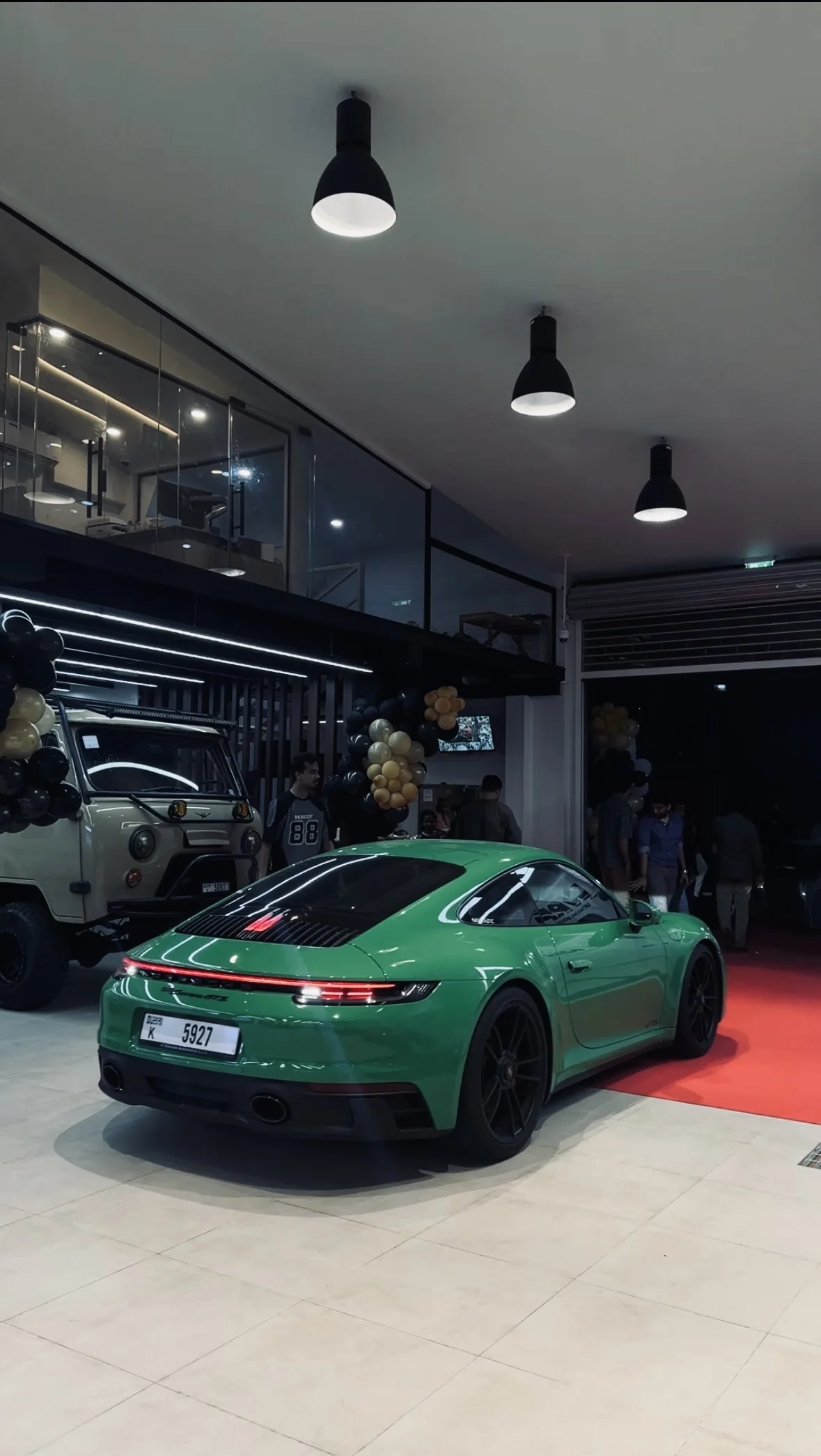 Green Porsche 911 showcasing mirror-finish paint correction and ceramic coating at WRP Dubai