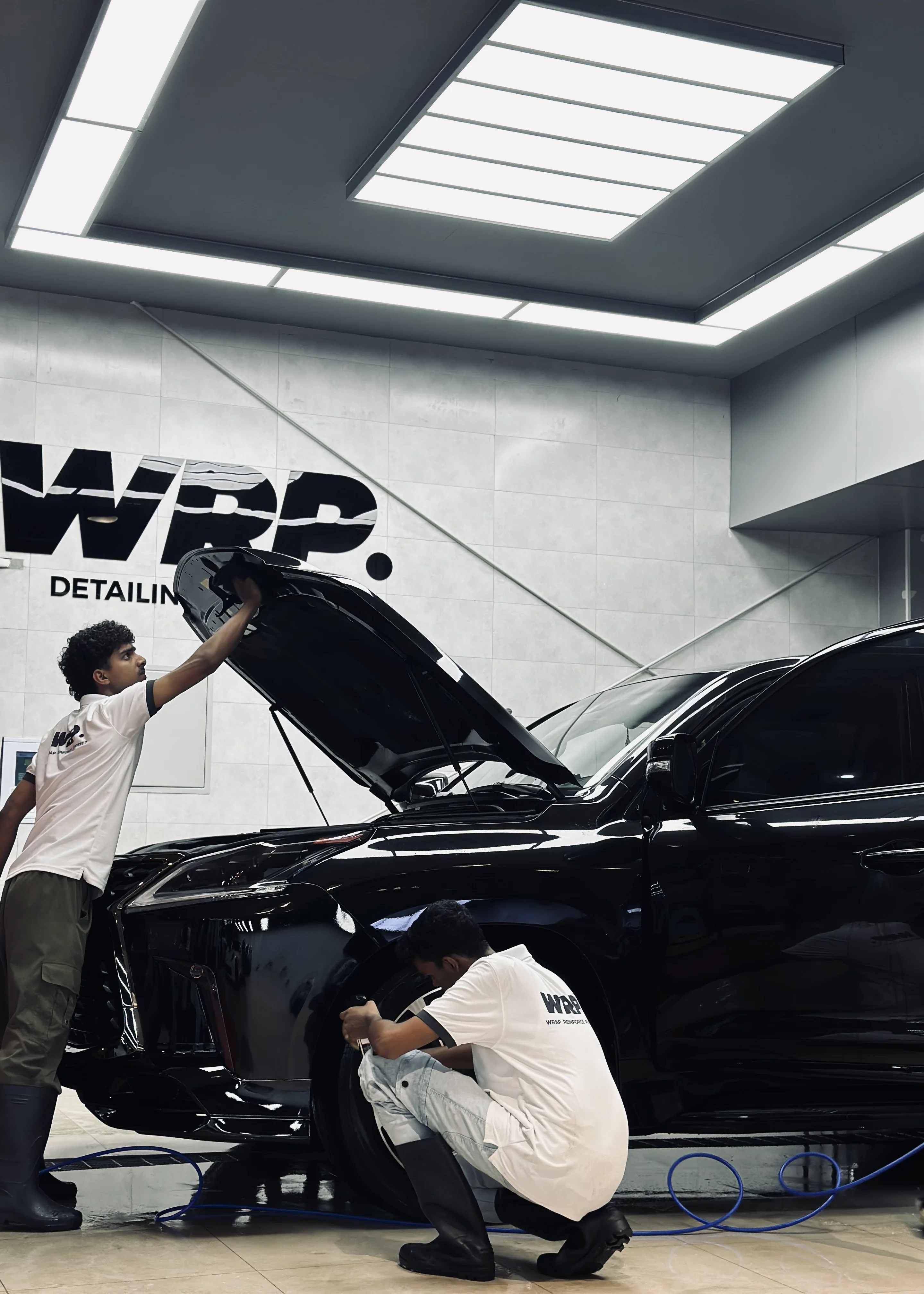 WRP Dubai technician applying professional ceramic coating on Lexus luxury vehicle hood