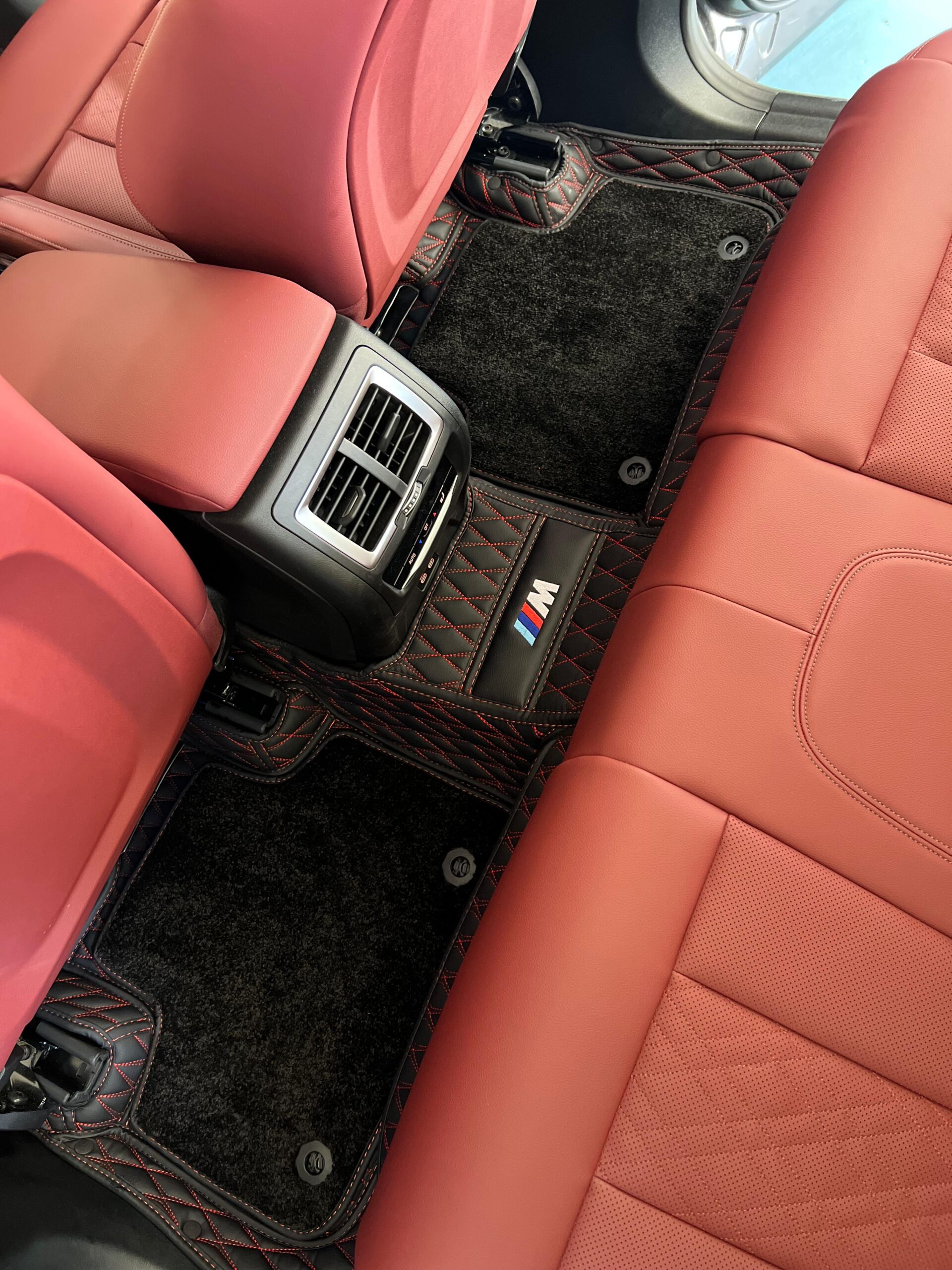 Premium 7D custom-fit car floor mat in black synthetic leather covering the rear passenger footwell, showing full-coverage contoured design with raised edges